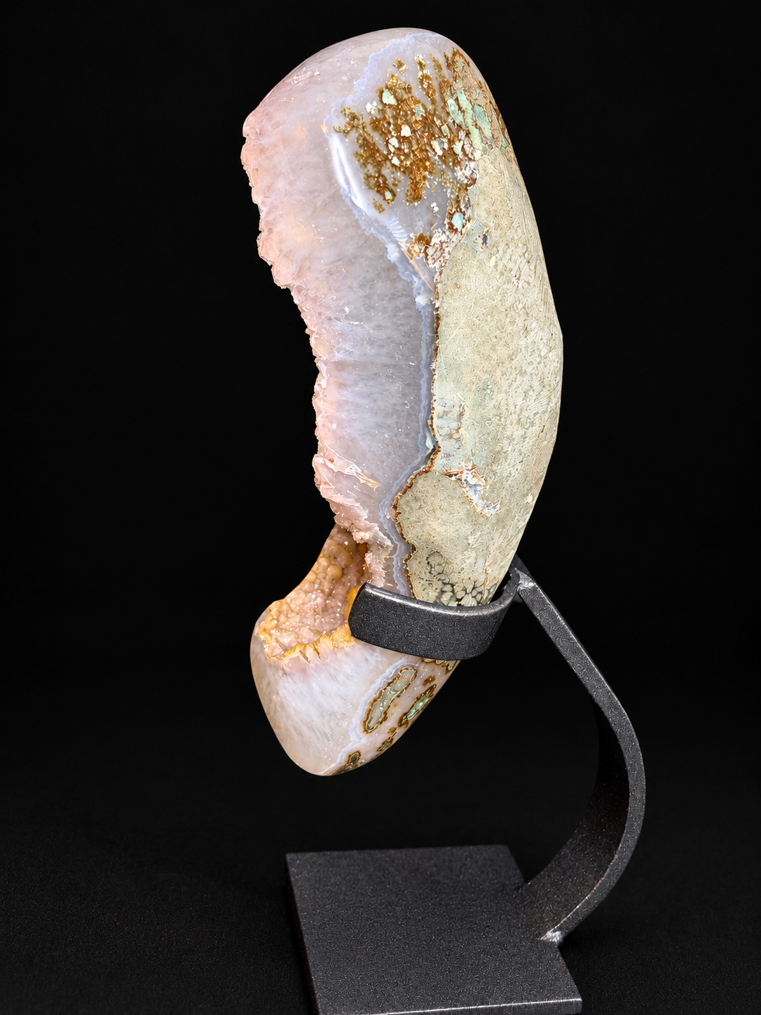Back view of a pale agate geode showing natural banded patterns — one-of-a-kind mineral specimen.