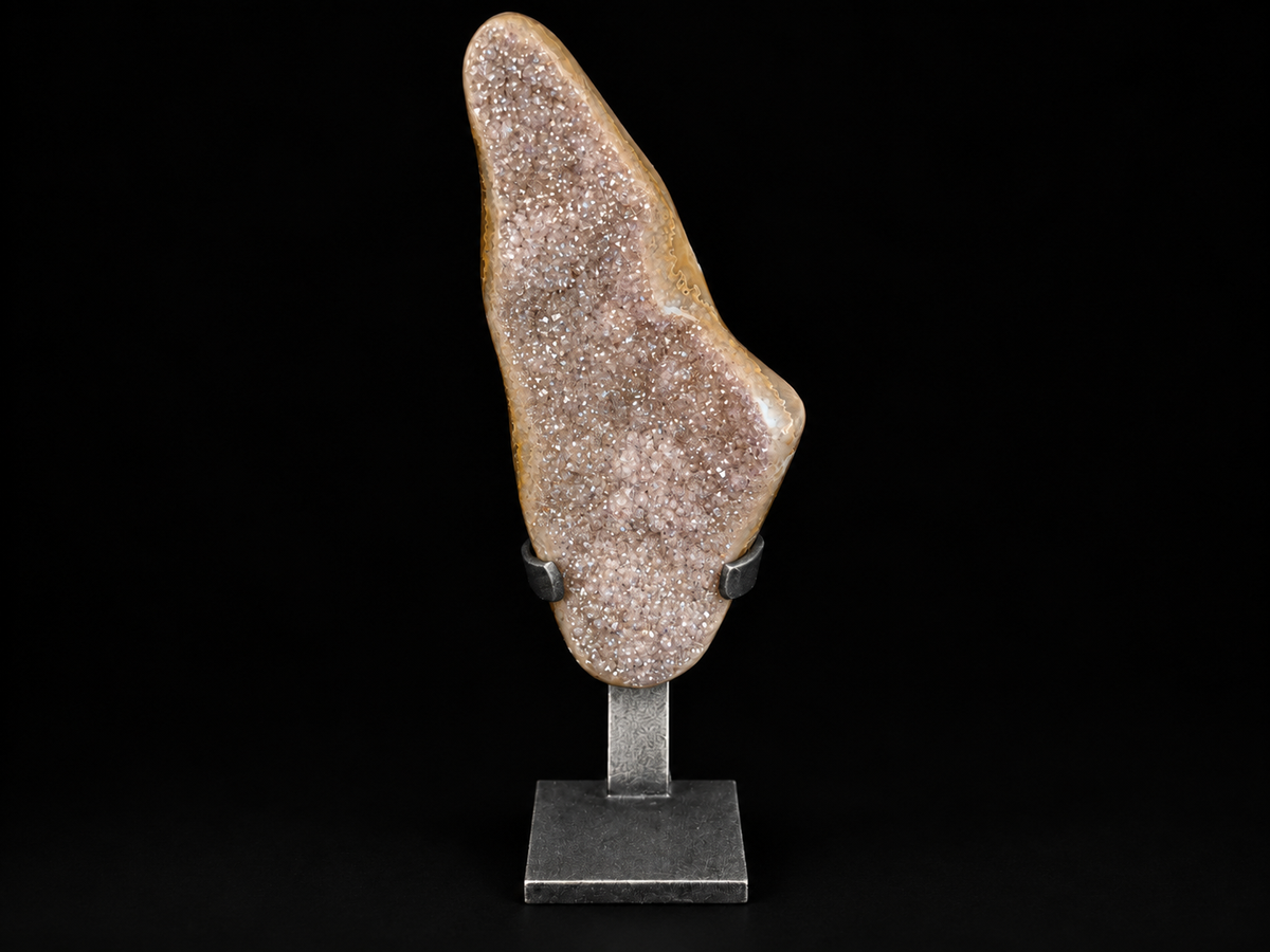A natural druzy crystal specimen with sparkling pinkish-lavender crystals, mounted on a black metal stand.