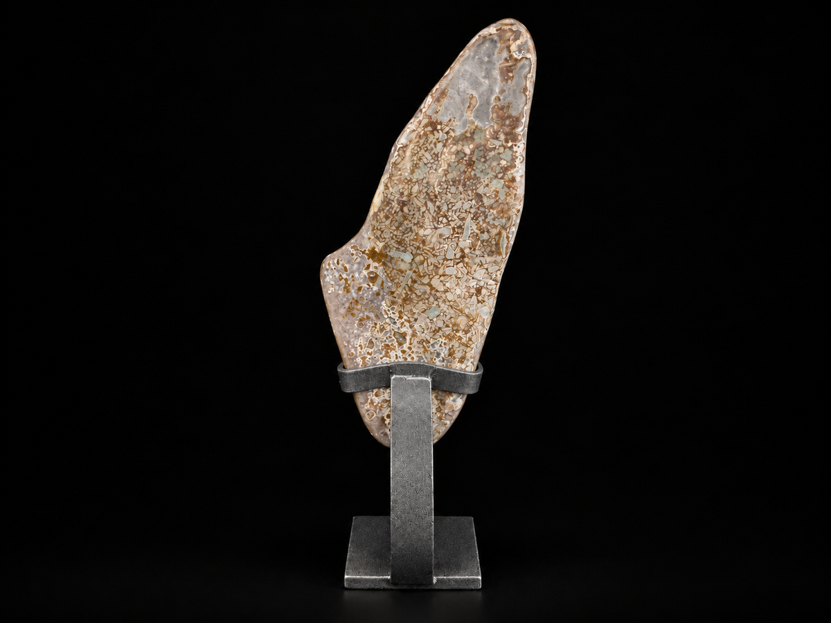 A natural polished agate specimen with a mottled beige, brown, and gray texture, displayed on a dark gray metal stand against a solid black background.