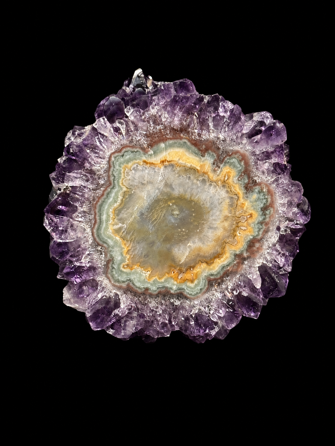 Natural polished amethyst stalactite slice shaped like a flower, with purple crystal points around a banded agate center.