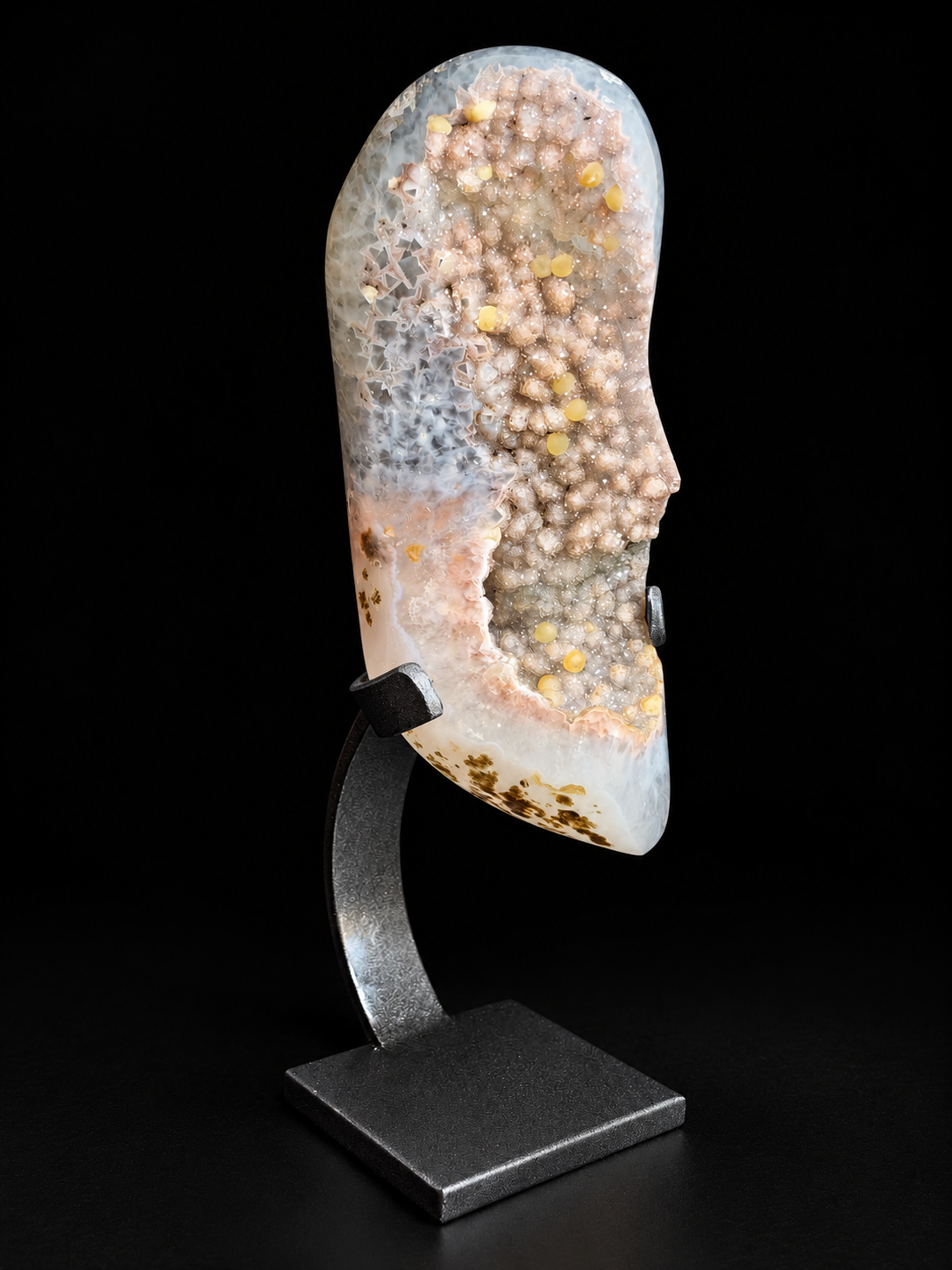 Pastel agate geode with sparkling druzy crystals and calcite on a display stand — natural mineral home decor.