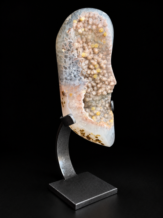 Pastel agate geode with sparkling druzy crystals and calcite on a display stand — natural mineral home decor.