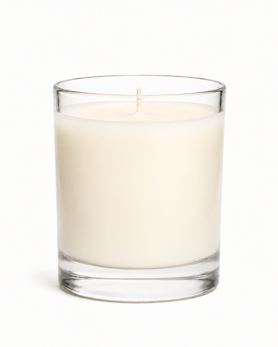 Clear glass candle with white wax inside on a white background