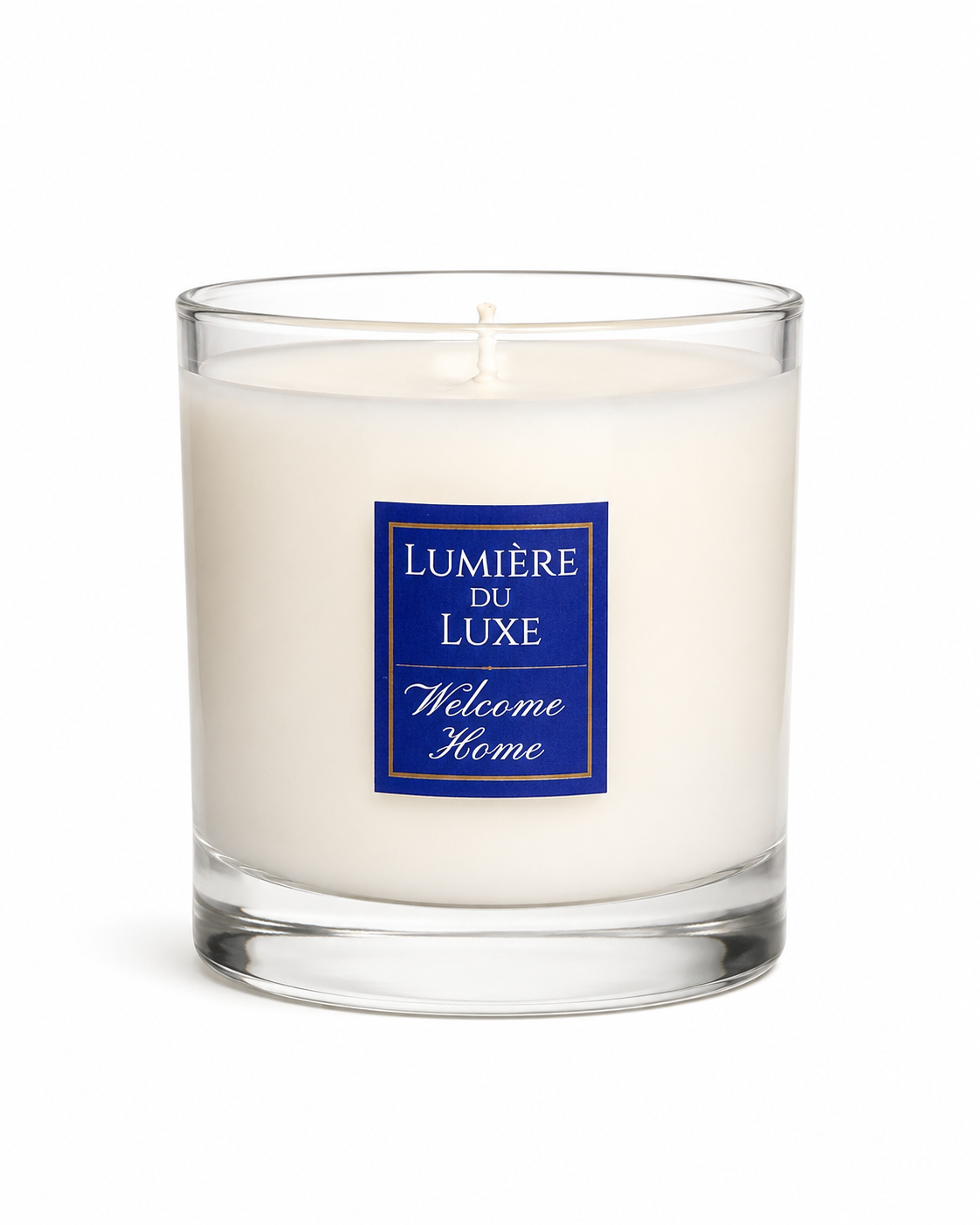 White Candle with a 'Lumérie du Luxe Welcome Home' label on a white background