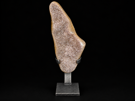 A natural druzy crystal specimen with sparkling pinkish-lavender crystals, mounted on a black metal stand.