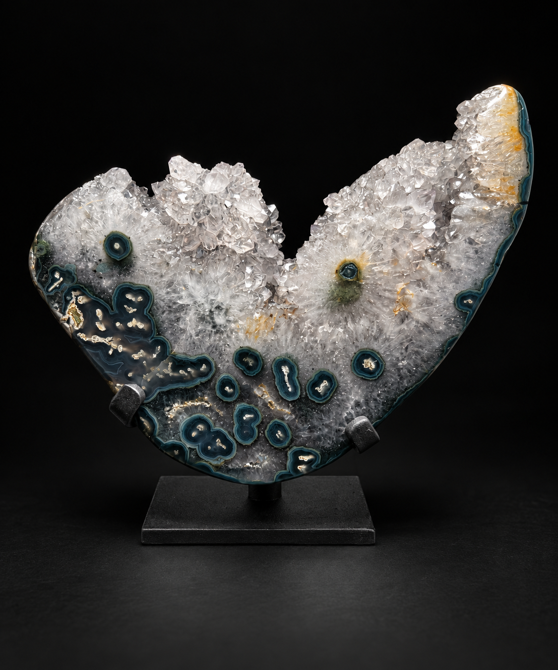 Sculptural agate specimen with stalactite eyes in clear quartz and deep green banding, on a black stand — one-of-a-kind.
