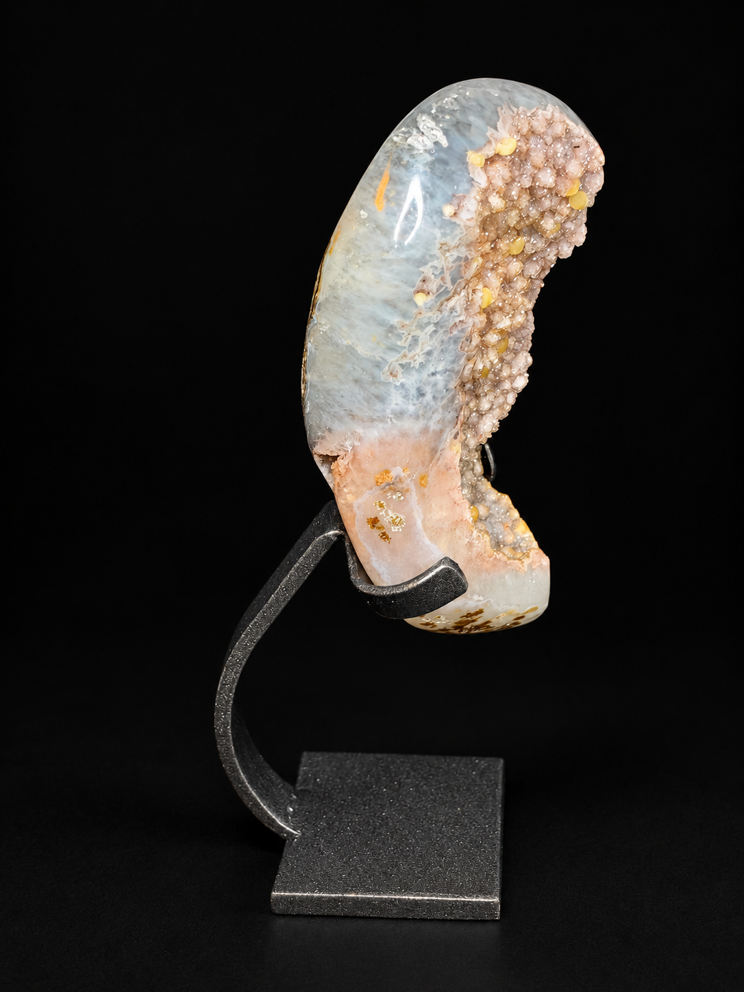 Side view of a pale agate geode with druzy crystals and calcite — natural crystal home decor.